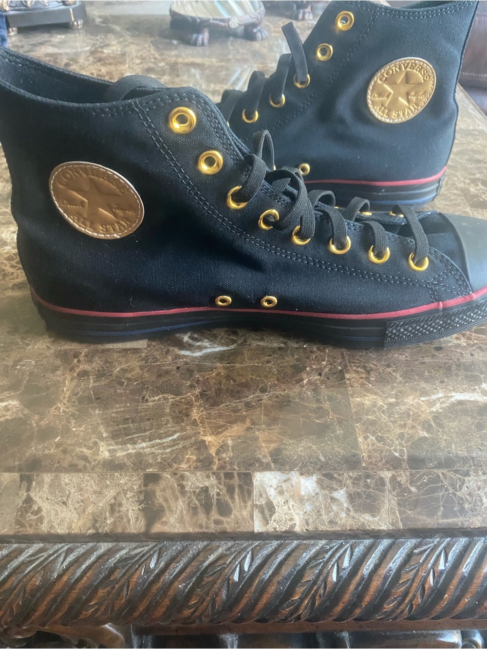 Converse mens Black High-Top Sneakers with Gold Accents and Red Stripe